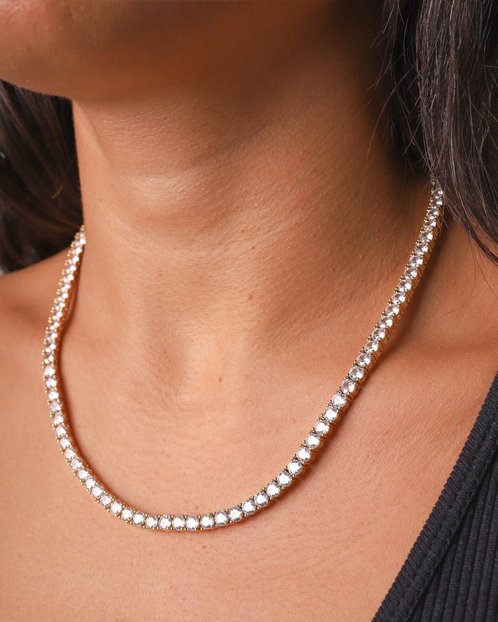 Gold Iced Tennis Chain 4 mm worn by a female model, angled view