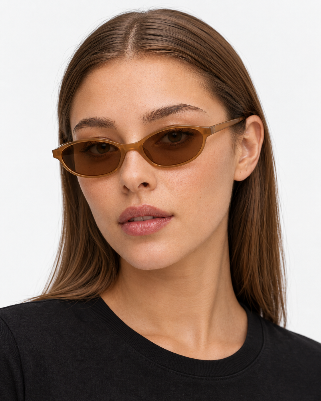 Oval Sunglasses in translucent amber with brown lenses, worn by a woman
