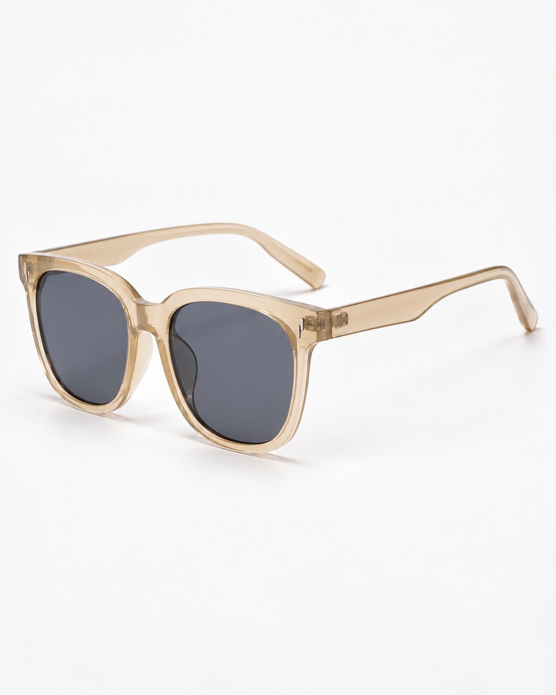 Oversized Square Sunglasses with a translucent champagne frame and grey lenses, three-quarter view