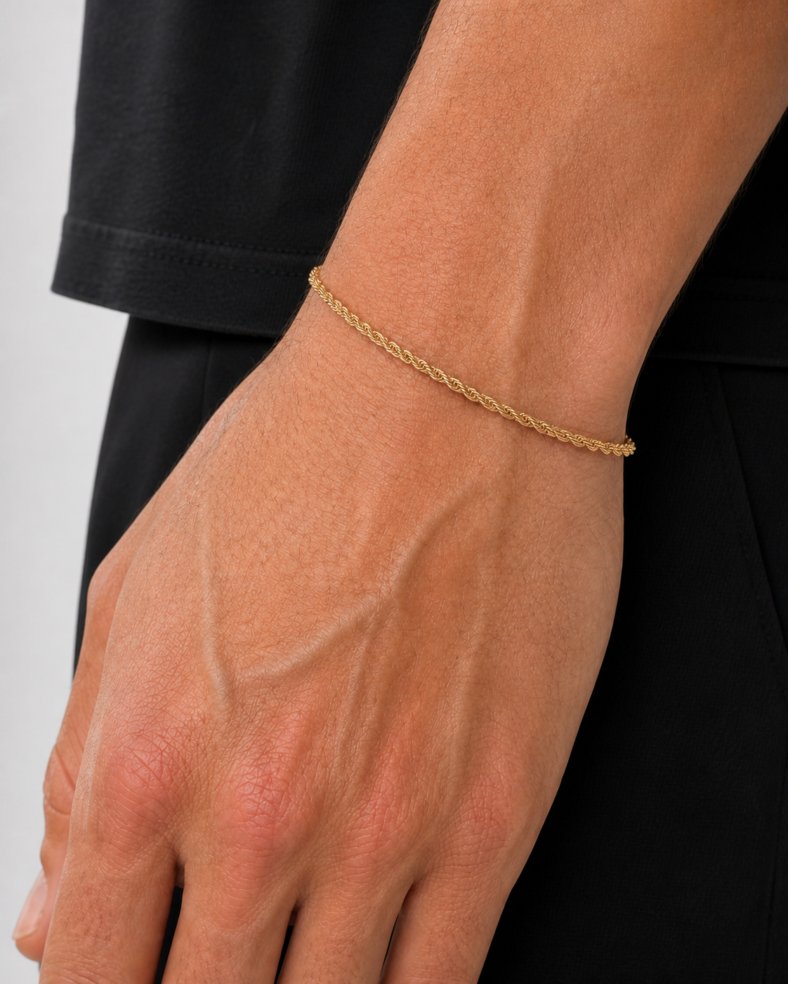 Gold Rope Bracelet 2 mm worn on Tyler's wrist