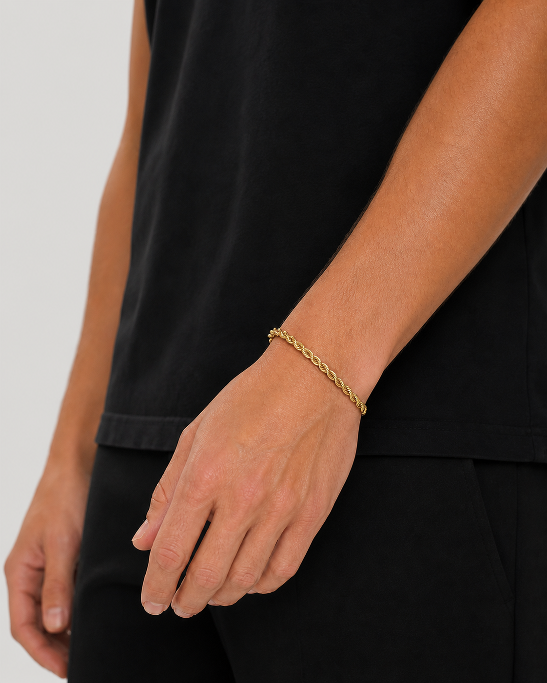Tyler wearing the 5 mm gold rope bracelet with his hand relaxed by his side