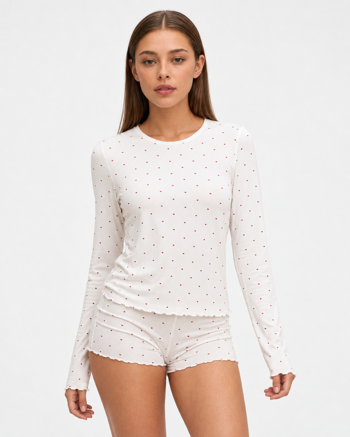 Sara wearing the Ruffle Jersey Sleep Set in white hearts, closer front view
