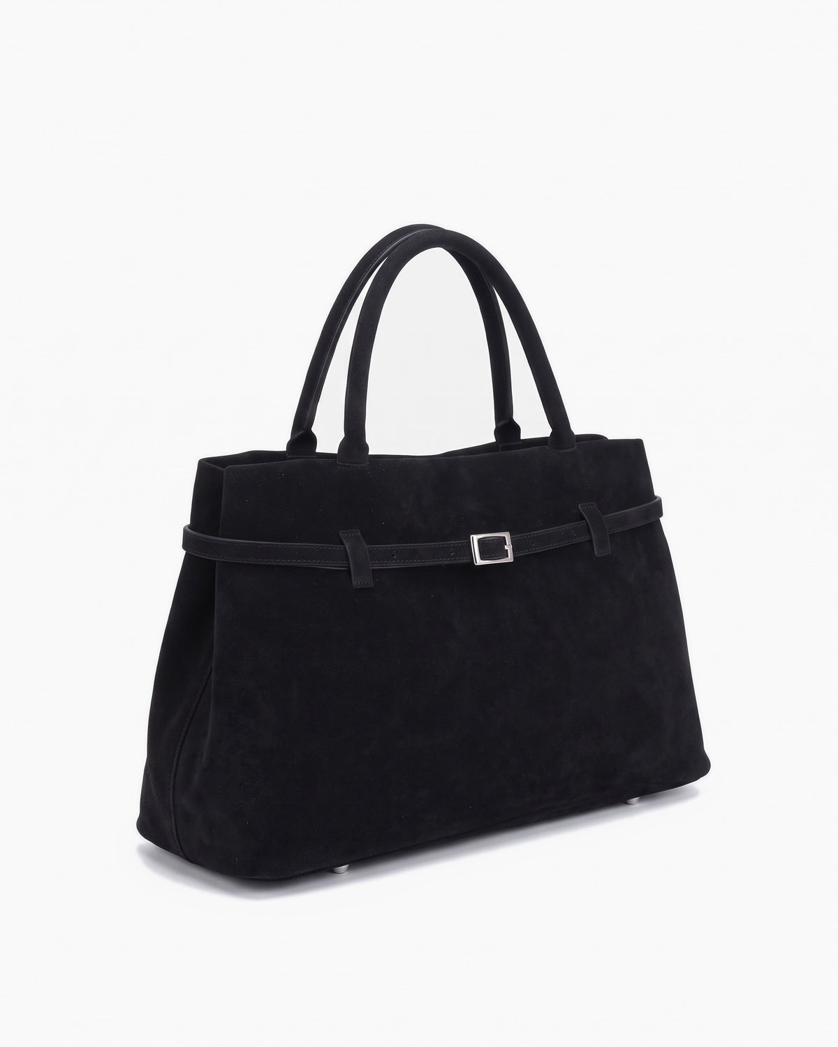 Black suede top handle bag with a slim belted front and square buckle, three-quarter view on a plain background