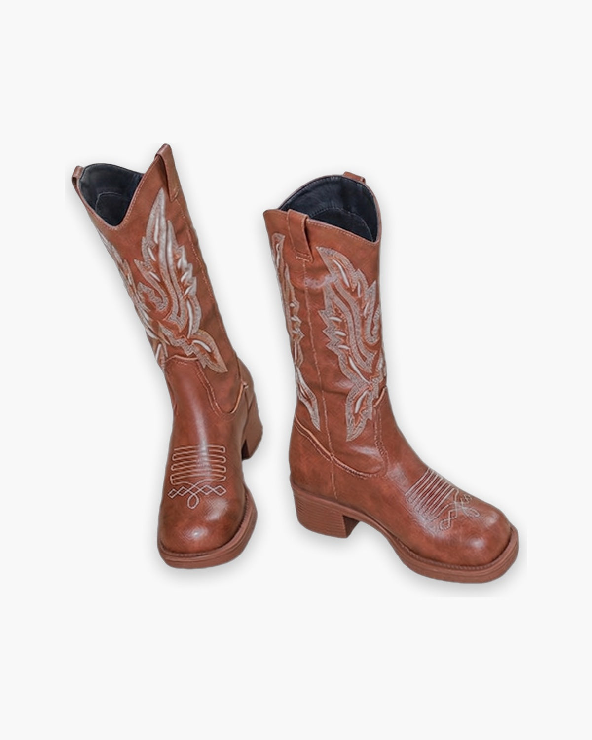 Pair of brown cowboy boots with tonal western embroidery, on a plain background