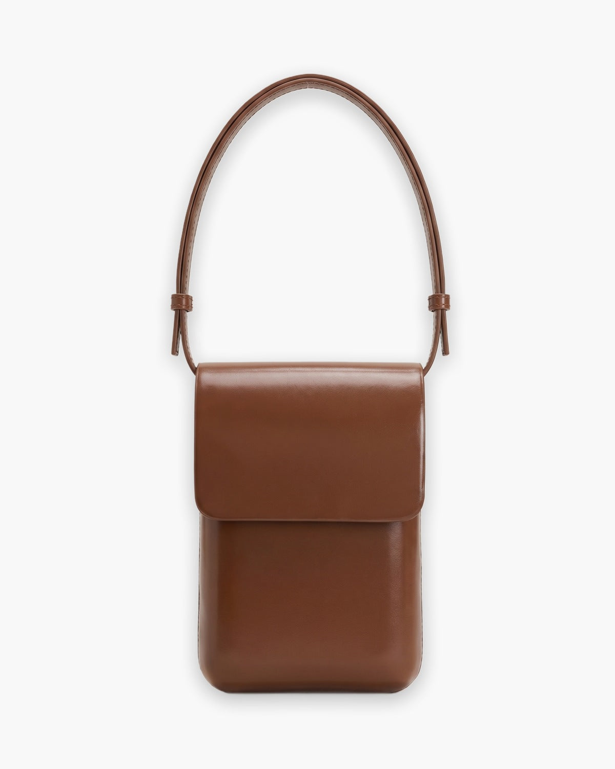 Cognac brown crossbody pouch with a fold over flap, on a plain background