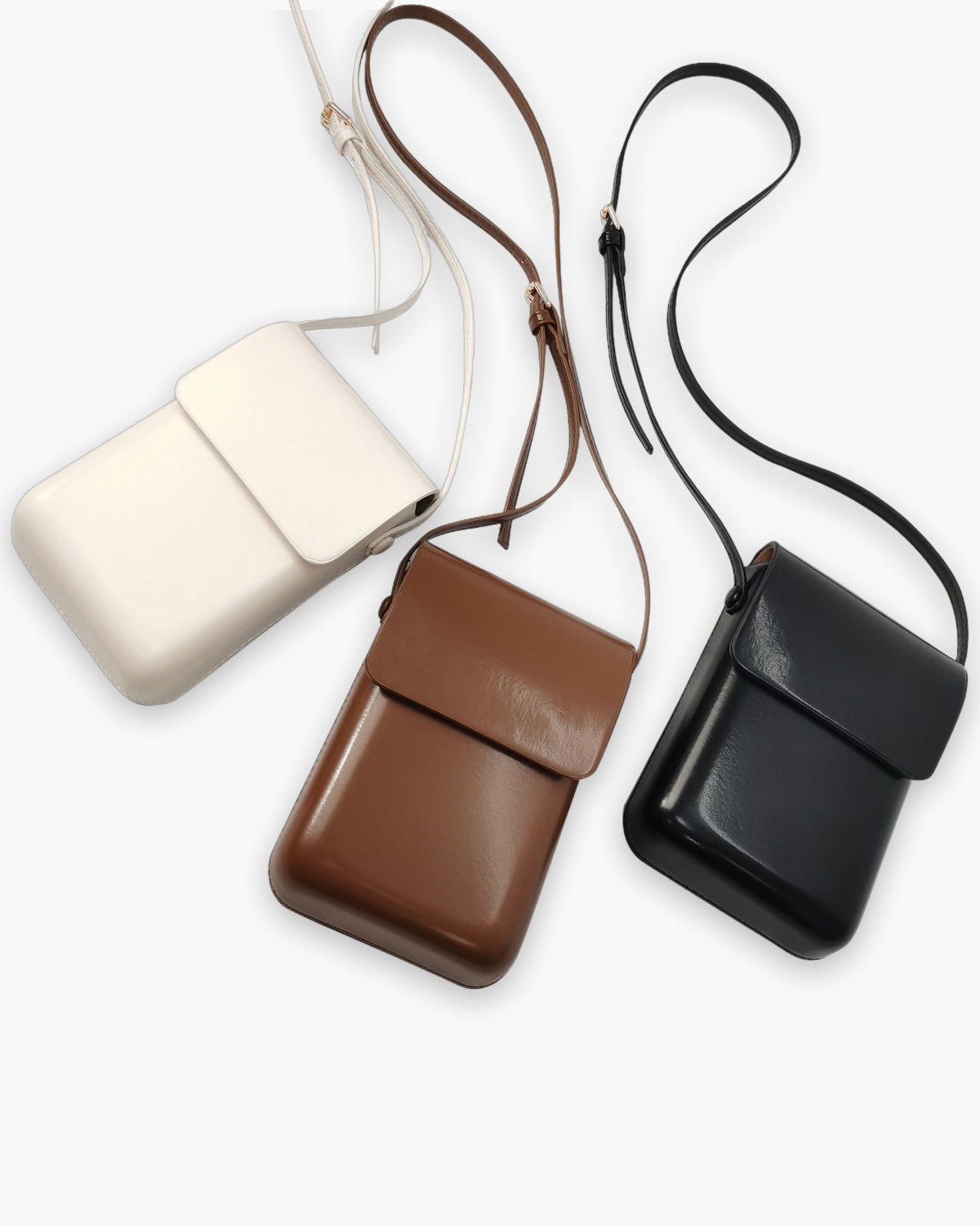 The crossbody pouch in ivory, cognac and black