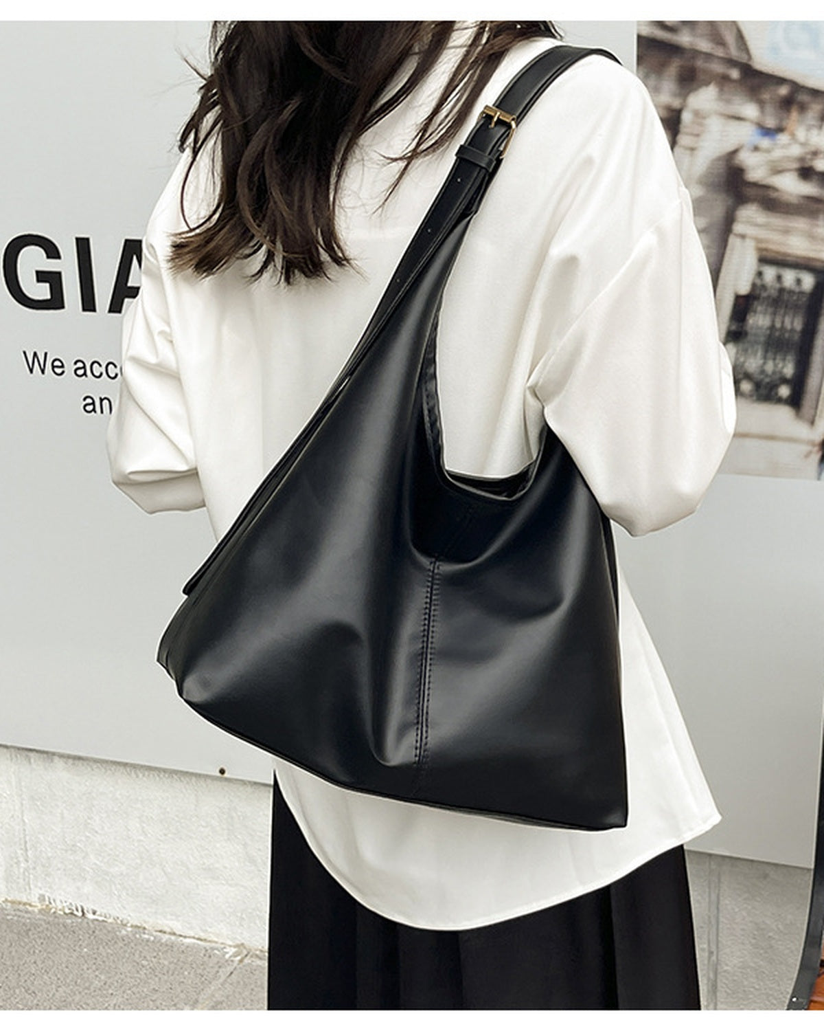Black slouchy shoulder bag worn on the shoulder