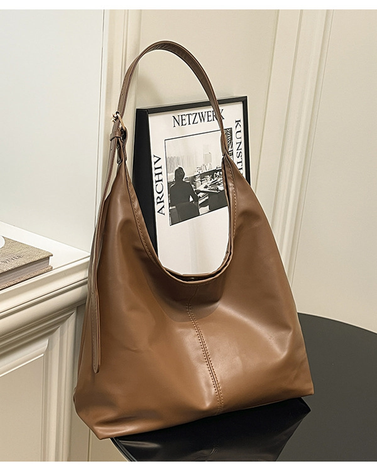 Brown slouchy shoulder bag standing upright on a table