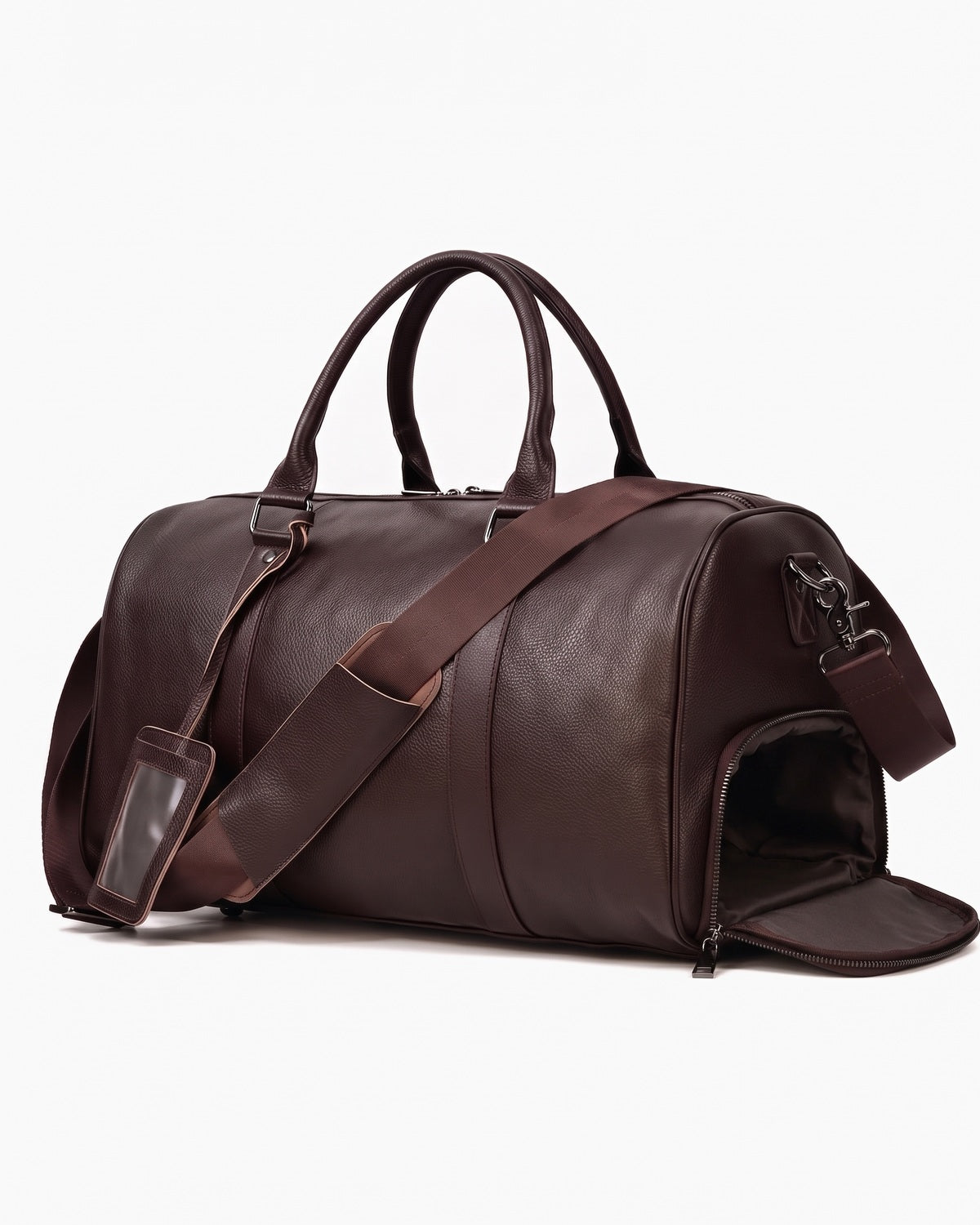 Brown leather weekender bag with the end shoe compartment unzipped and open, on a plain background