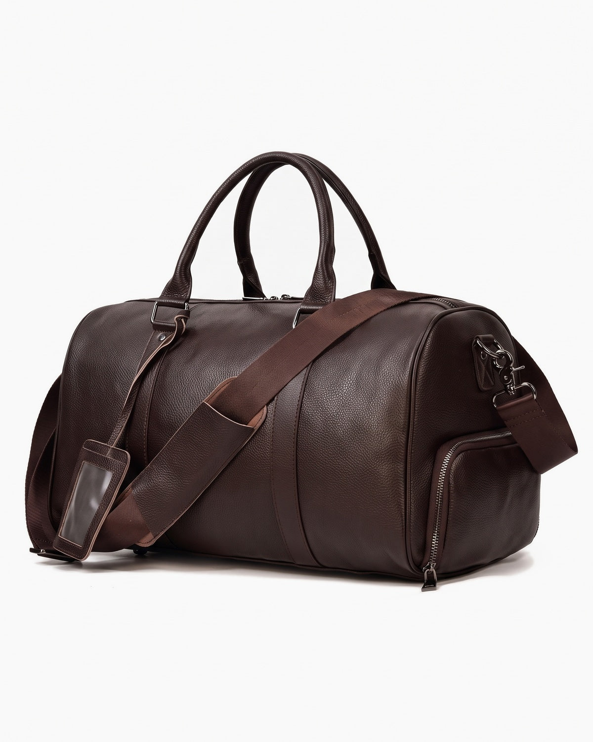 Brown leather weekender bag with twin handles and detachable strap, three-quarter view on a plain background
