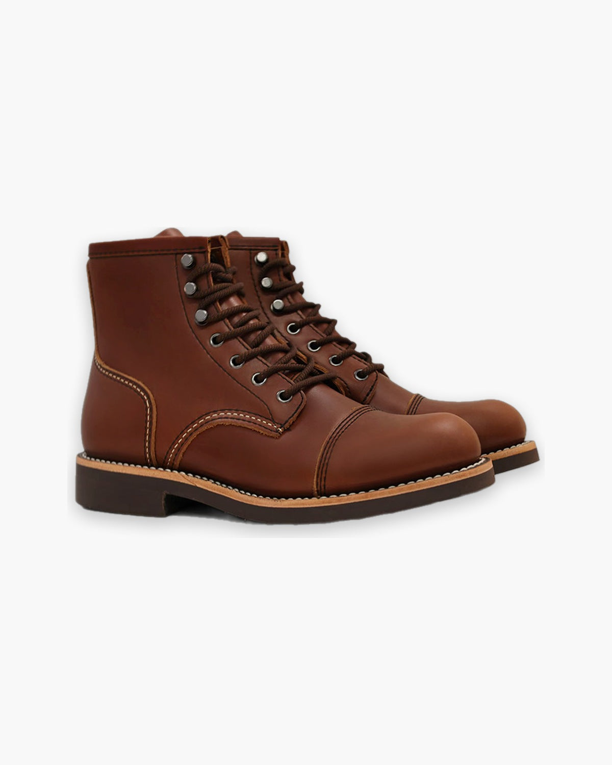 Brown leather work boots, front three quarter view on a plain background