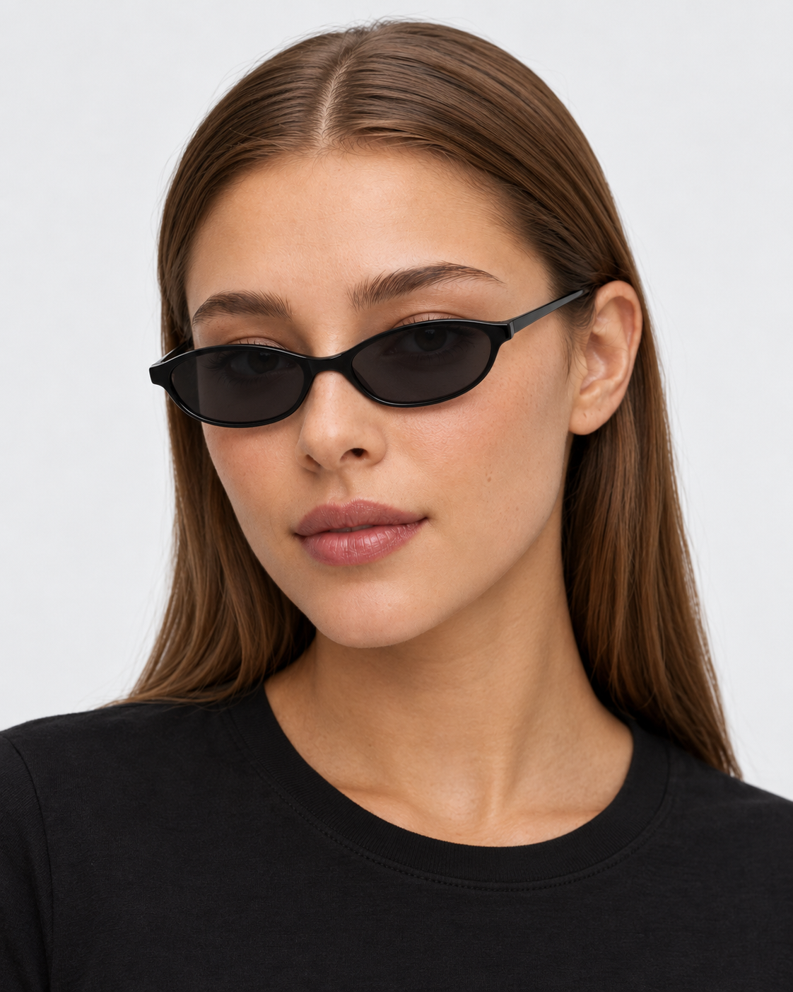 Oval Sunglasses in gloss black with grey lenses, worn by a woman