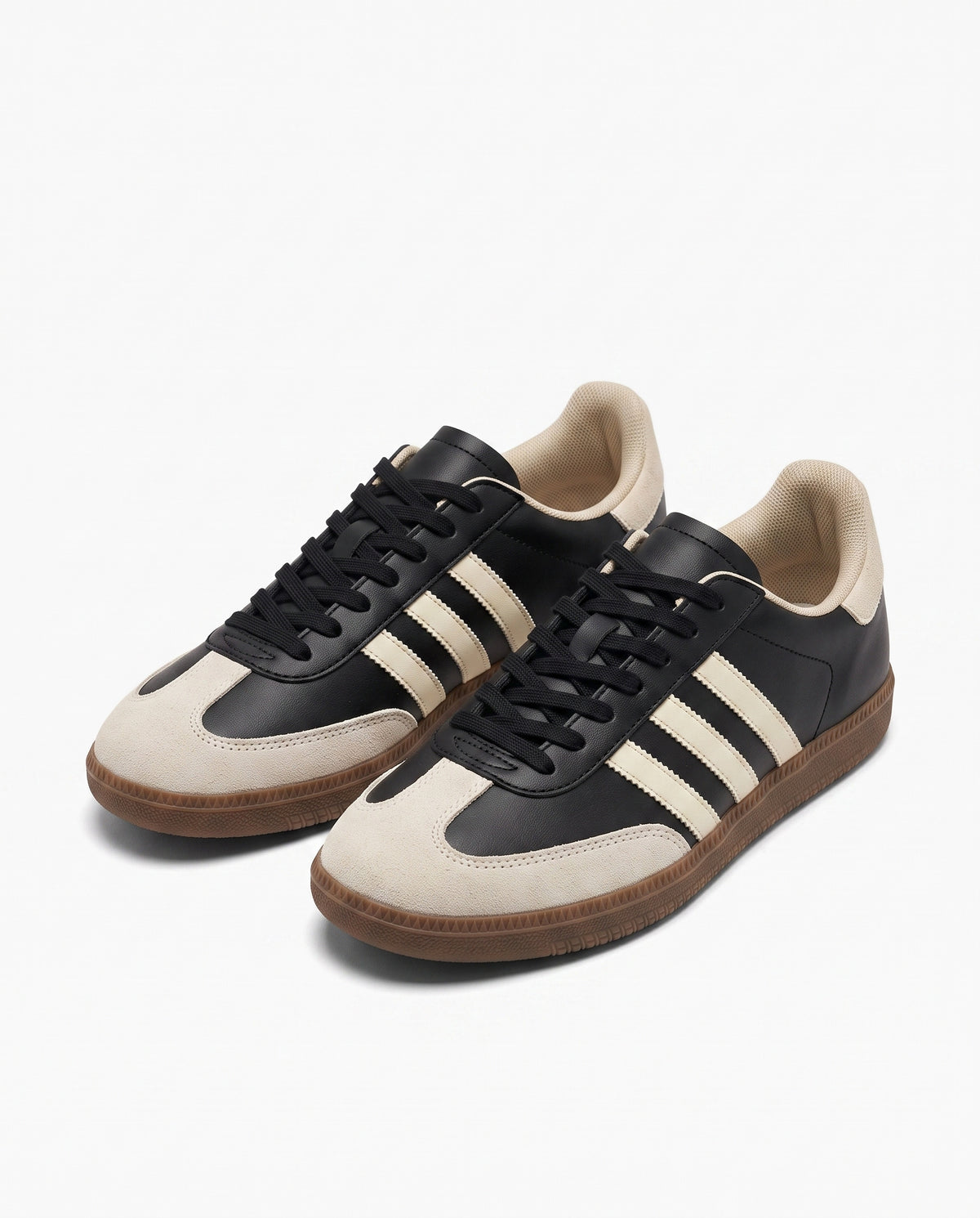 Black retro low top sneaker with cream side stripes, cream suede toe and brown gum sole, studio product shot