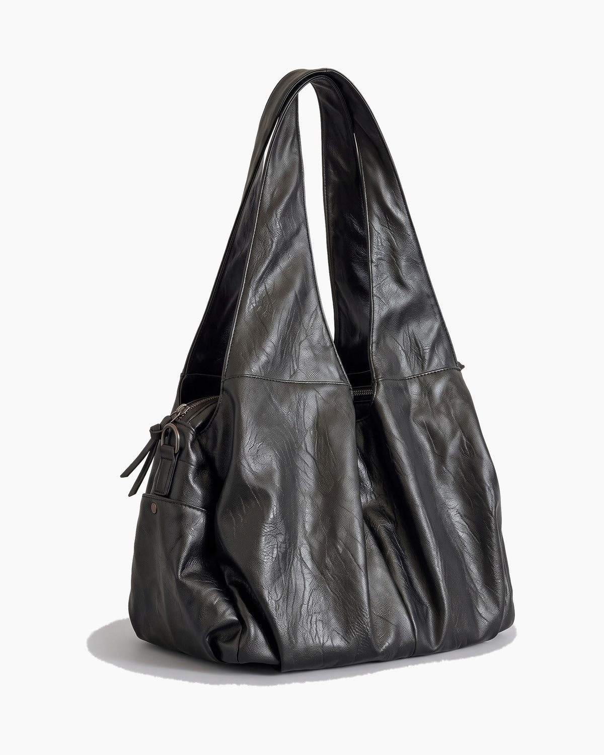 Black soft shopper bag turned to show its side gusset and zip, on a plain background