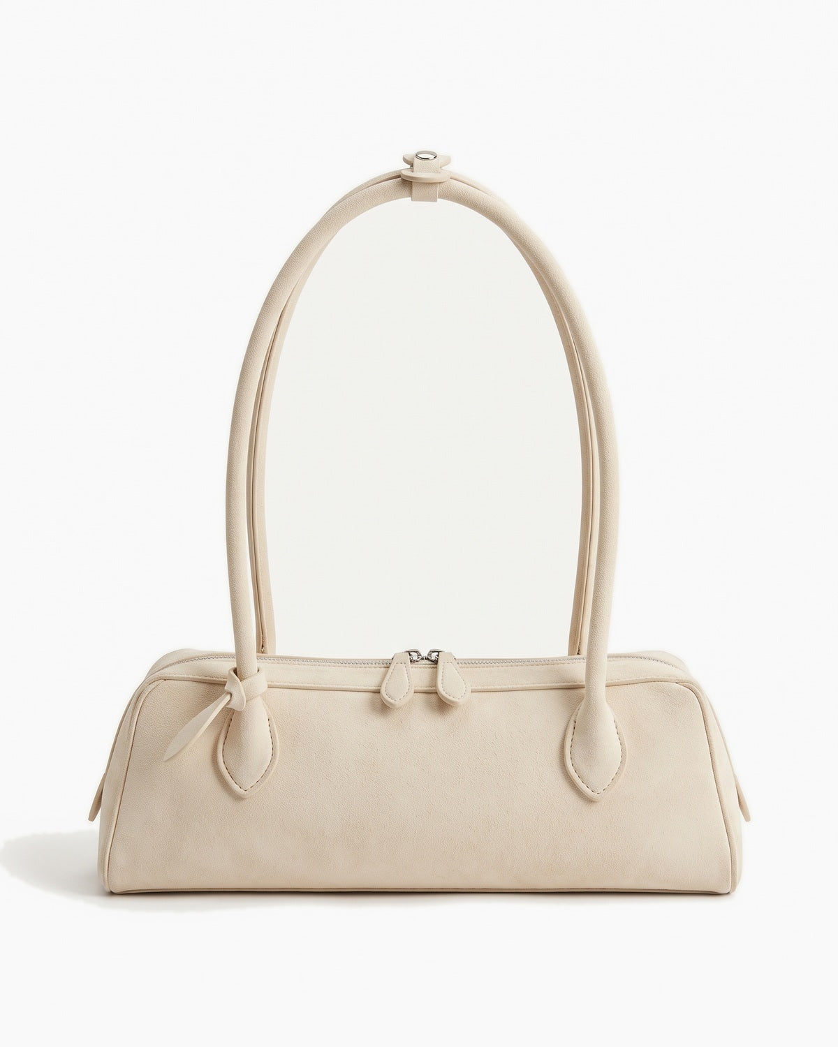 Soft ivory suede baguette bag with a top zip and twin short straps, on a plain background