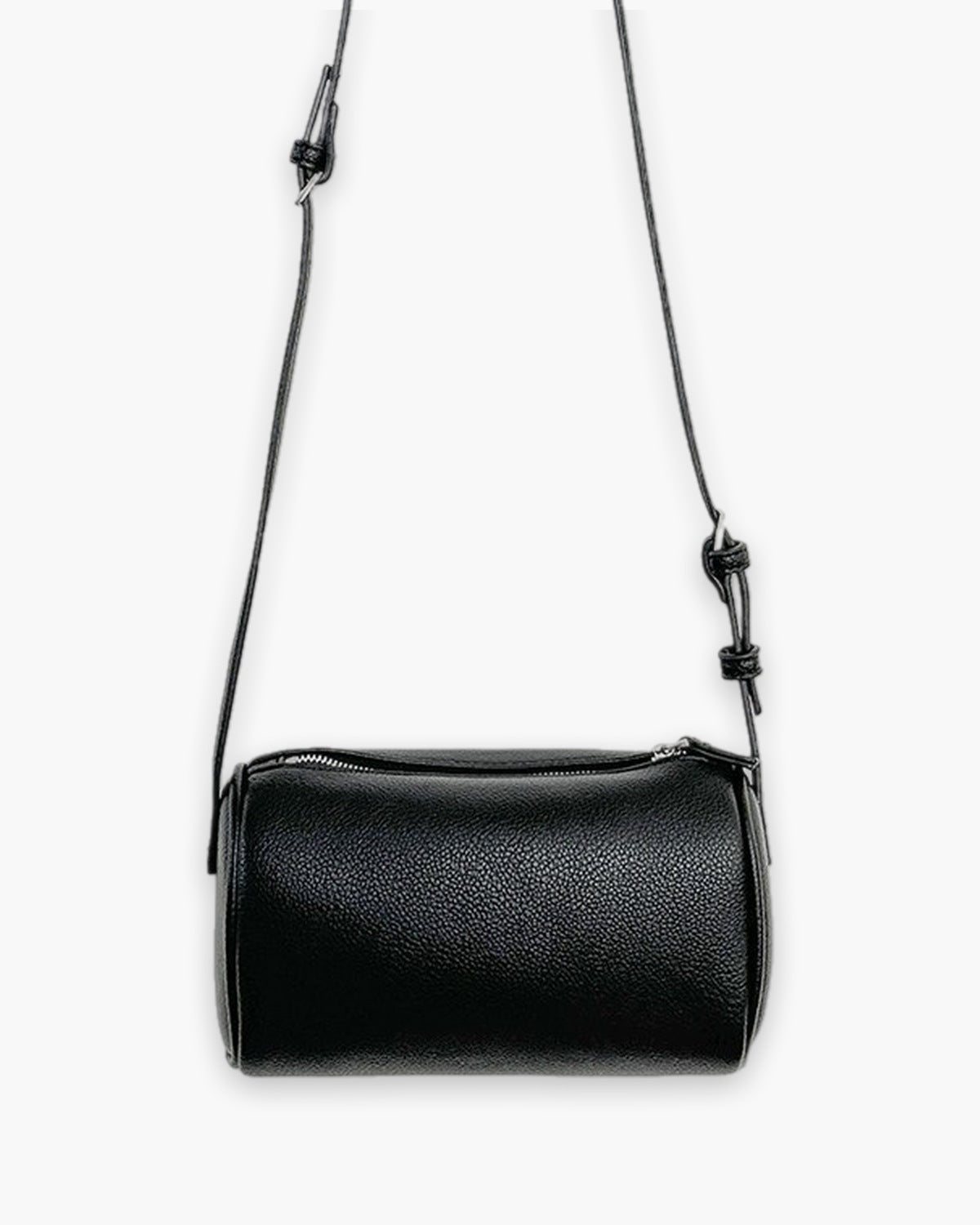 Black barrel-shaped crossbody bag with a full length top zip, on a plain background