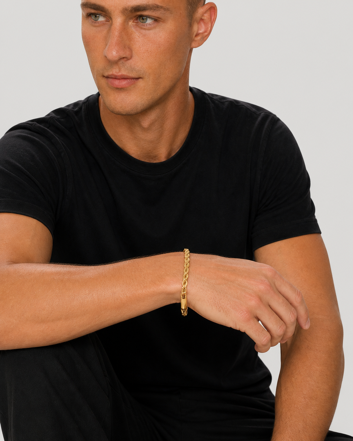 Tyler wearing the 5 mm gold rope bracelet in a seated studio portrait