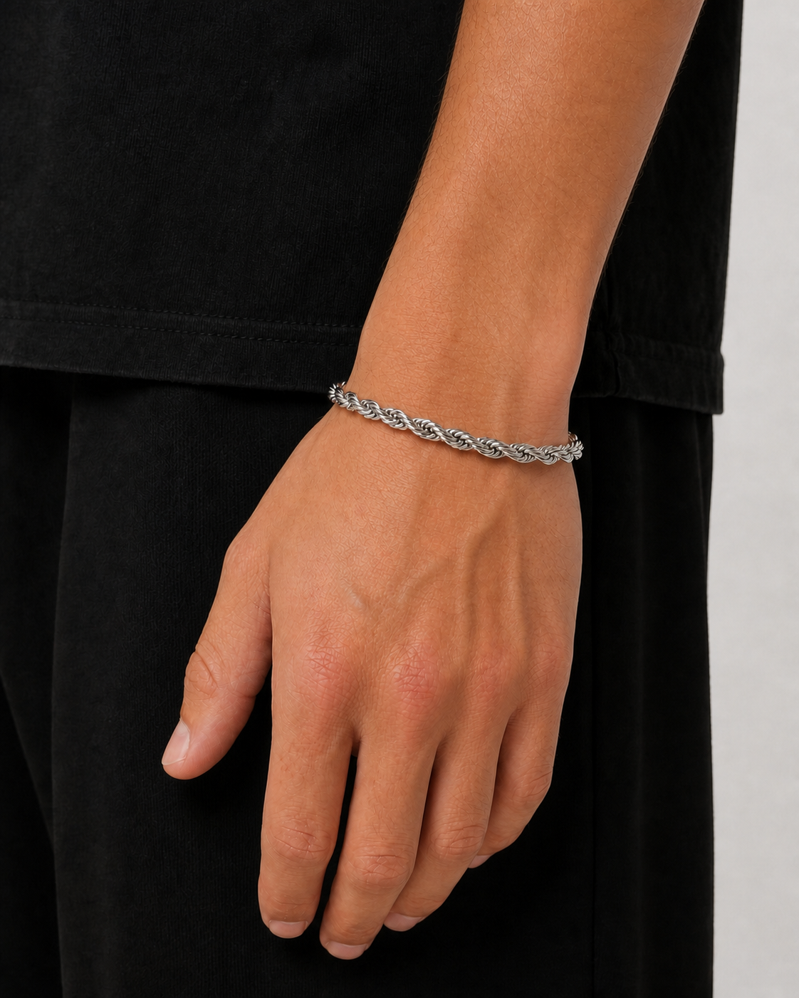 Silver 5 mm rope bracelet worn with the arm relaxed at the side